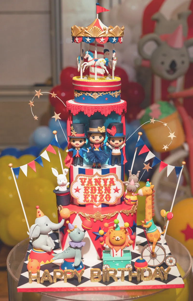 Circus themed multi-tier cake with carousel topper