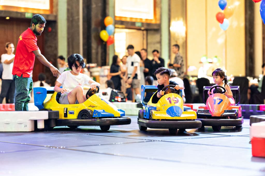 Kids racing go-karts at a Hot Wheels-themed birthday party