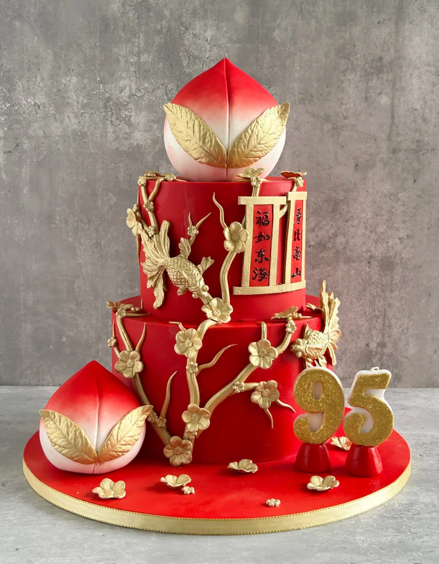 Red and gold longevity peach cake with plum blossoms for a 95th birthday