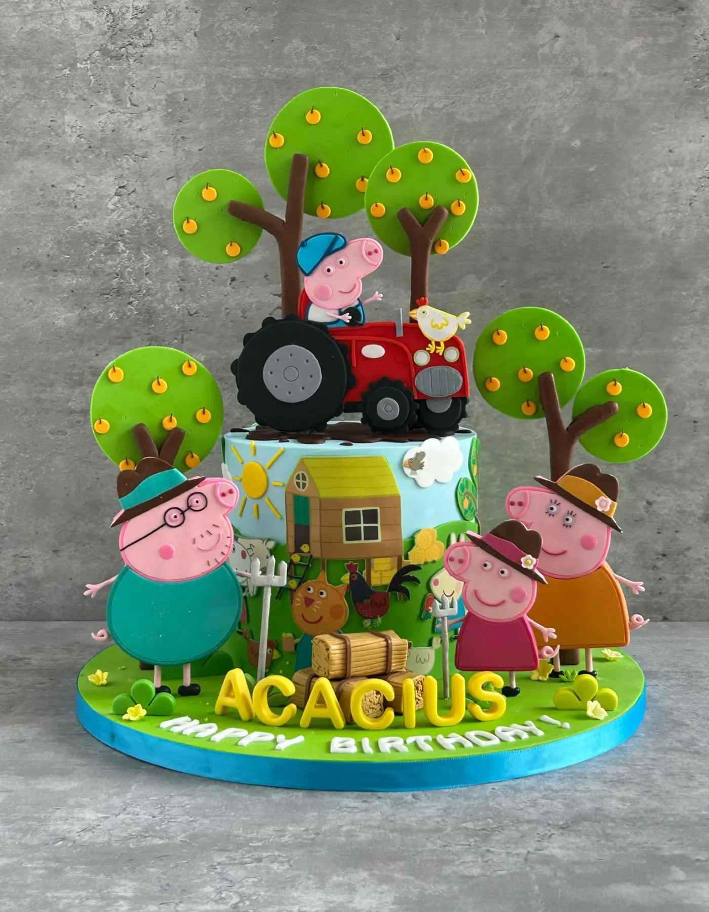 Peppa Pig farm-themed birthday cake with tractor, trees and sculpted characters